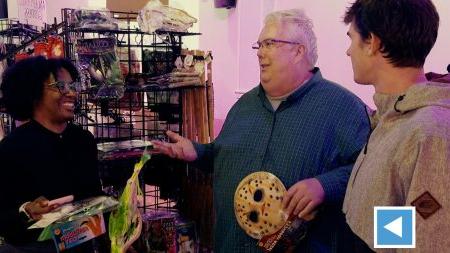 Professor Tim Flood talks with students inside the Heel-O-Ween pop-up store